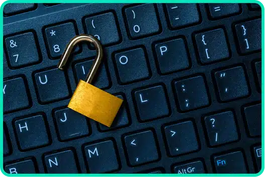 An unlocked padlock placed on a computer keyboard symbolizing a data breach and compromised security